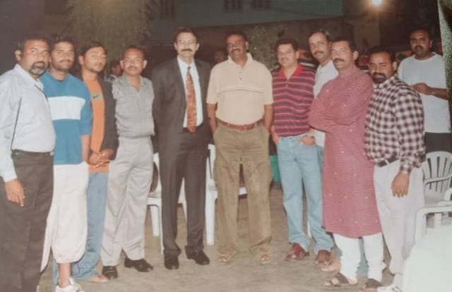 A group of men standing together in an old photograph