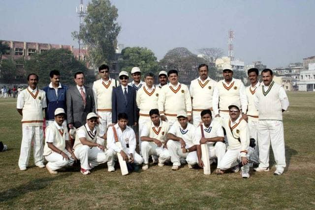 A team in cream kit with officials on a ground